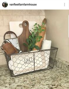 a wire basket filled with kitchen utensils on top of a granite countertop