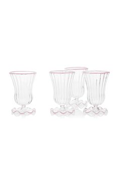 three clear glass vases sitting next to each other on top of a white surface