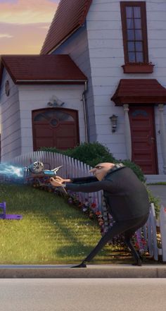 the animated character is hitting another character with a baseball bat in front of a house