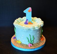 a blue birthday cake with an under the sea theme