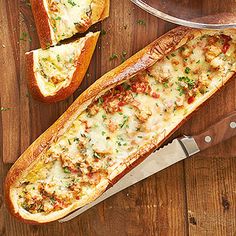 two pieces of bread with cheese and meat on them next to a large knife that has been cut in half