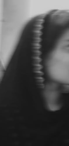 a blurry photo of a woman's face and hair in black and white