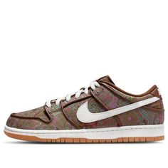 The Nike Dunk Low Pro Premium SB 'Paisley' is a stylish sneaker inspired by 70's T-shirts. It features a brown upper with a Paisley print, and a mix of pink, green and burgundy. The white Swooshes on the side, along with the matching tongue and heel branding, complete the design on a white midsole and rubber sole. Perfect for everyday wear, this sneaker is also suitable for a variety of activities such as skateboarding and casual outings. This adult-sized sneaker is part of the Nike SB Dunk Low series and is set to release on 2022-03-29. (SNKR/Skate/Unisex/Low Top) Brown Retro Custom Sneakers For Streetwear, Nike Casual Sneakers With Graphic Print, Nike Retro Brown Sneakers, Retro Brown Sneakers For Skateboarding, Vintage Nike Brown Sneakers, Vintage Brown Nike Sneakers, Dunk Low Paisley, Nike Sb Dunk Low Pro, Dr Shoes