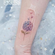 a small hydrant tattoo on the left forearm and right arm, with flowers growing out of it