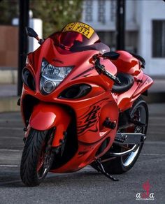 a red motorcycle is parked on the street