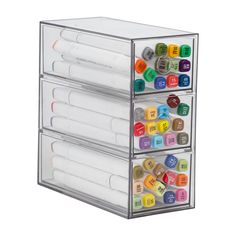 the four drawers are filled with pens and markers, all in clear plastic cases