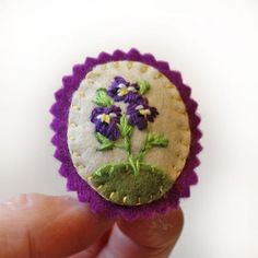 Pansies hold a special place in many people's hearts. I think it is their little faces that make them so appealing to us. This little felt pansy brooch is hand embroidered with the classic violet or purple pansies.Felt Flower Pin Dimensions: Metric: H5cm x W4cm (at widest point) Imperial: H2inches x 1 6/8inchMADE TO ORDER: Please note that this brooch is made to order. Other colours and designs can be made.Custom Orders: Other colours and designs can be made to order. Please message me to discus Felt Pins, Purple Pansies, Felt Crafts Christmas, Felt Roses, Unique Valentines Day Gifts, Purple Pansy, Embroidered Roses, Hand Embroidered Flowers, Felt Embroidery