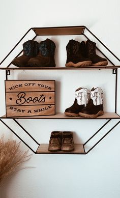 two shelves with shoes and a sign that says kick off your boots stay a wild