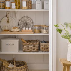 the shelves in this kitchen are filled with various items