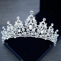 a tiara is displayed on a black surface