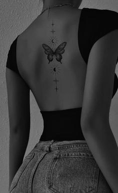 a woman with a butterfly tattoo on her back