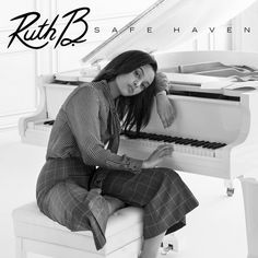 a woman sitting on top of a piano in front of a white piano with the words ruti b safe haven