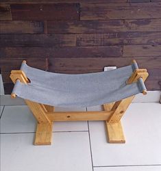 a wooden bench sitting on top of a tiled floor