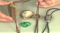 two hands are working on an object with beads and other items in the foreground