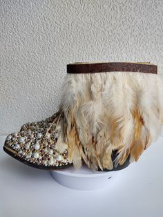 Meet 'Clutch my Pearls'! These are not your grandmother's pearls!  But they are still gone with the wind fabulous!  Elevate your style with these upcycled blingy cowboy boots - a blend of eco-chic and feminine charm. This pair, uniquely crafted from a blend of new and repurposed materials, is adorned with a mix feathers, rhinestones, beads and belts.  These took several days to complete!  Each rhinestone and pearl added one by one! These pre-loved boots not only make a fashion statement but also a sustainable choice for the conscious fashionista.  Part of the process of crafting these is taking a full height boot then cutting and folding to make this fabulous bootie!  Festivals and Carnivals, here we come! As a bonus, we'll ship in a plastic shoe bin which can also be used to store these b Shoe Bin, Plastic Shoes, Eco Chic, Gone With The Wind, Cowboy Western, Western Cowboy Boots, Western Cowboy, Western Boots, Boot Shoes Women