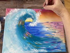 someone is painting a wave in the ocean with watercolors on paper and acrylic paint