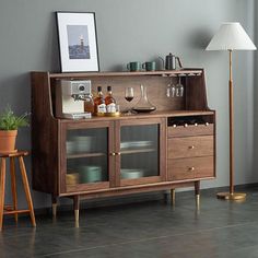 a wooden cabinet with wine glasses and bottles on it