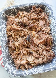 shredded meat in a baking dish on a table