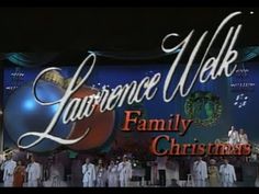 a group of people standing in front of a sign that says lawrence walk family christmas