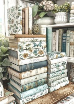 a stack of books sitting on top of a wooden table