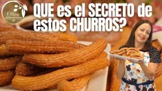 a woman holding a tray of churros in front of some other food items