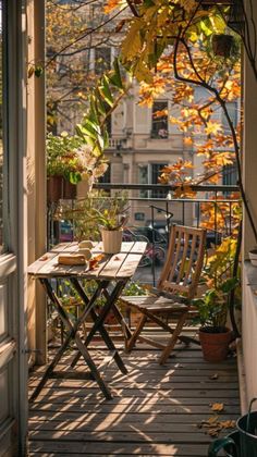 a balcony with chairs, table and potted plants