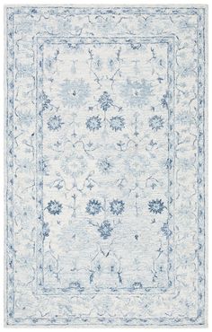 a blue and white rug with an ornate design on the bottom, in front of a white background