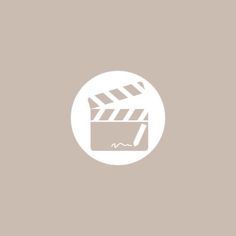 a movie clapper in a white circle on a beige background with the words,