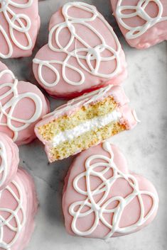 pink and white decorated cookies on a marble surface