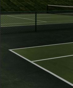 a man standing on top of a tennis court holding a racquet