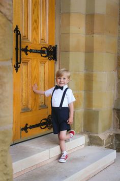 My current processing time is 3-4 weeks before shipping. Please do not order if you need your item(s) before then :)  If you're looking for the perfect vintage style oufit for your little guy, look no further! These navy blue linen suspender shorts are perfect for weddings, baptisms, holidays, christenings, family photos, or dressed down for everyday wear.  They are made of a soft linen blend with a luxurious texture, and feature a flat front, for a classic tailored fit, and elastic in the back waistband. The suspender straps button on to the shorts in the front and back, and have two buttonholes in the back to be able to adjust for longer wear. A velvet ribbon strip where the suspenders cross keeps the straps from slipping off of the shoulders. The suspenders are completely removeable, al Toddler Boy Suspender Outfits, Toddler Wedding Outfit Boy, Boys Wedding Outfit, Boy Wedding Outfit, Baby Boy Wedding Outfit, Baby Boy Suspenders, Boys Ring, Baby Boy Easter Outfit Infants, Ring Bearer Boy