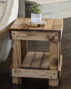 a small wooden table with a potted plant on top