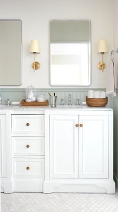 a white bathroom with two sinks and mirrors