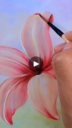 someone is drawing a flower with a pencil and watercolors on the paper in order to learn how to paint it