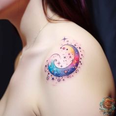 a woman's shoulder with a crescent and stars tattoo on her left side breast