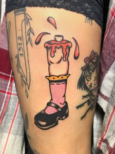 a woman's leg with tattoos on it