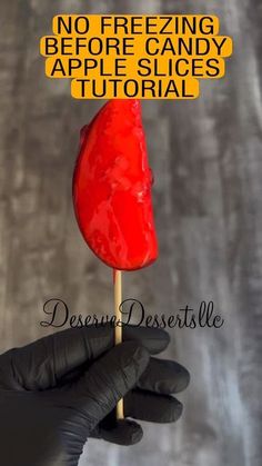 a hand holding a candy lollipop with the words, no freezing before candy apple slices