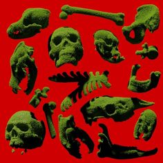 a bunch of green skulls and bones on a red background with the same type of bone