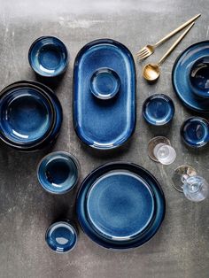 blue dishes and utensils laid out on a table