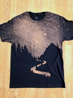 a t - shirt with trees and mountains on it