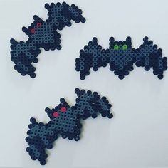 three pieces of lego art made to look like bats