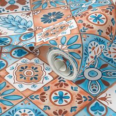 an orange and blue tile wallpaper with flowers on it