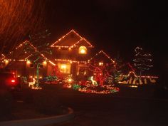 a house covered in christmas lights at night