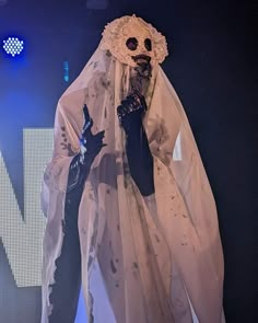 a person in a ghost costume on stage