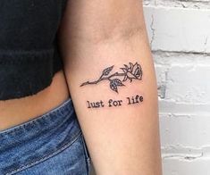 a woman with a tattoo on her arm that says just for life