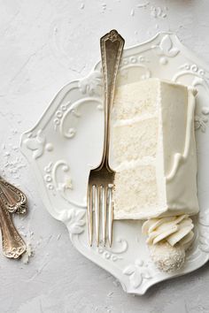 a piece of cake sitting on top of a white plate next to a knife and fork