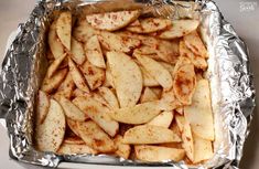 an aluminum pan filled with sliced apples on top of a table