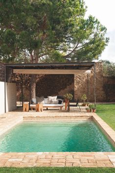 a pool with a couch and table next to it