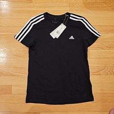 Brand New With Tags Women Adidas Black T-Shirt Size Small Adidas Basic T-shirt With Three Stripes, Basic Adidas T-shirt With Three Stripes, Black Cotton T-shirt With Three Stripes, Black Cotton Top With Three Stripes, Black Cotton Tops With Three Stripes, Casual Black T-shirt With Three Stripes, Black Crew Neck T-shirt With Three Stripes, Black Three Stripes Crew Neck T-shirt, Black T-shirt With Three Stripes