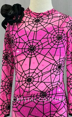 a pink and black costume with spider webs on it